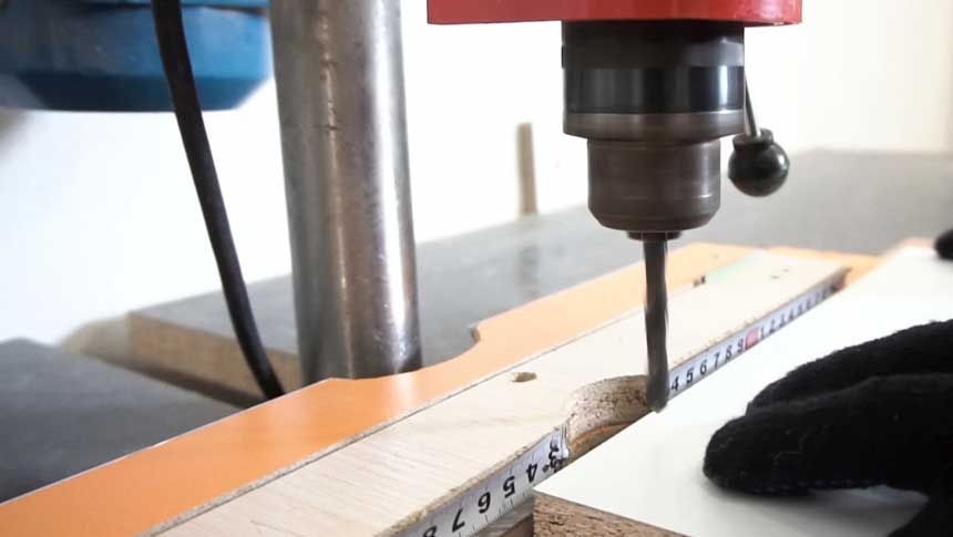 man working with drill press table